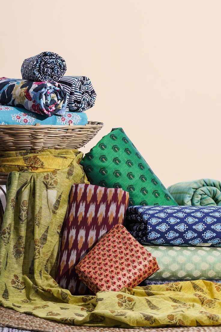 Stacked fabric swatch bundles in rich colors